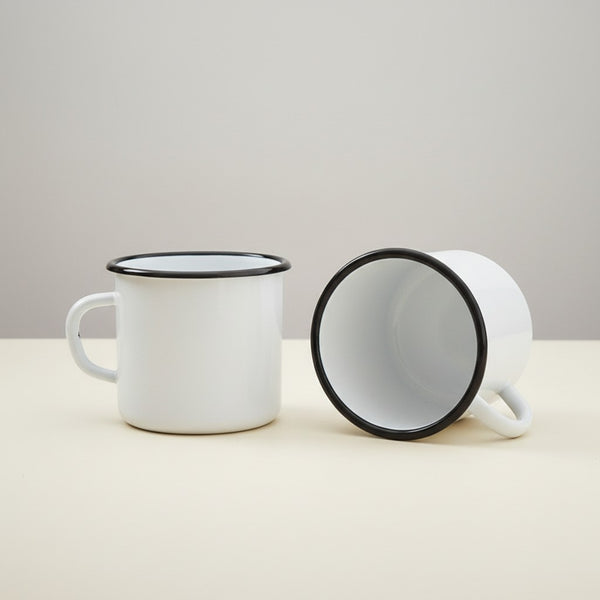 Vaisselle Emaillée white enamel mugs with black rim, 250ml capacity, sold as a set of two.