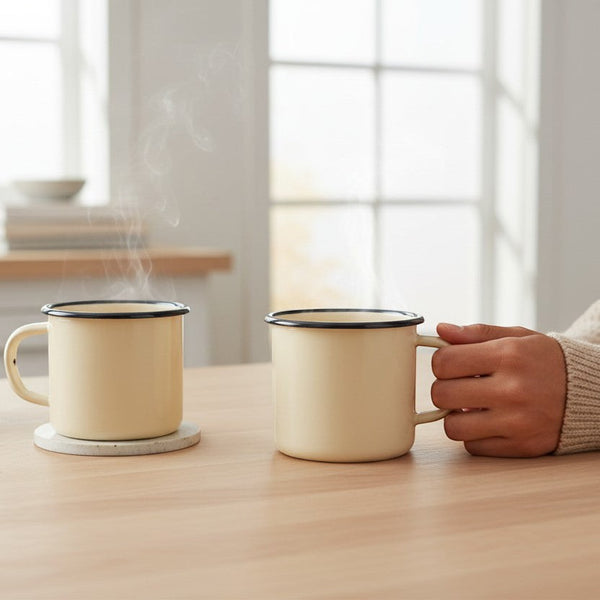 Vaisselle Emaillée set of 2 yellow enamel mugs with black rim, 250ml capacity, perfect for hot or cold drinks.