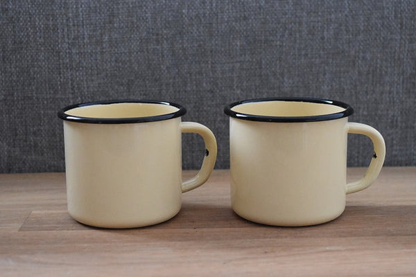 Vaisselle Emaillée set of 2 yellow enamel mugs with black rim, 250ml capacity, for hot or cold drinks.